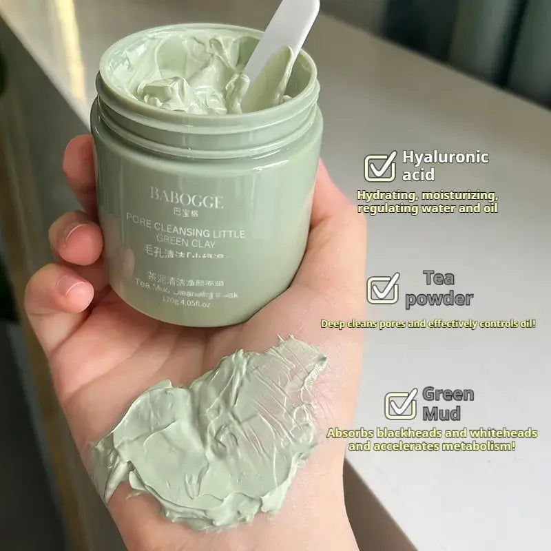 Tea mud cleansing facial mask in a jar, showcasing its green clay texture, enhancing deep pore cleansing and skin revitalization.